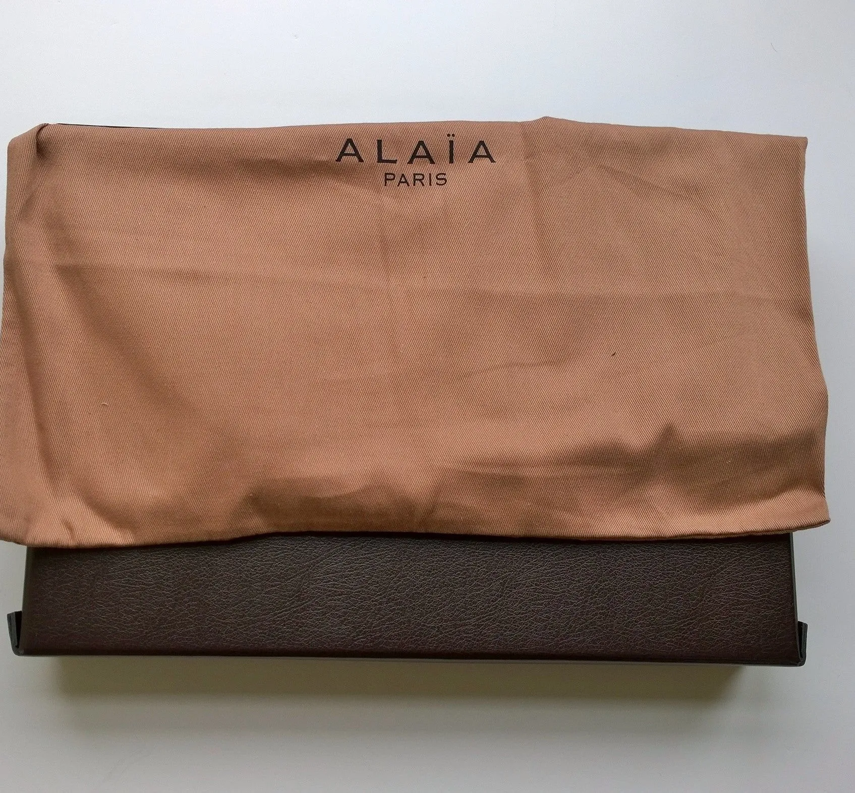 Alaia Arabesque Leather Laser Cutout clutch bag in beige nude and red purse