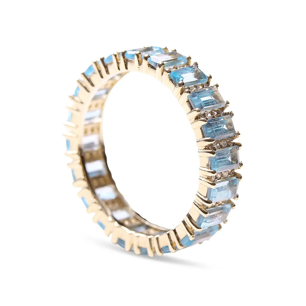 BLUE TOPAZ AND DIAMOND BAGUETTE CUT ETERNITY BAND