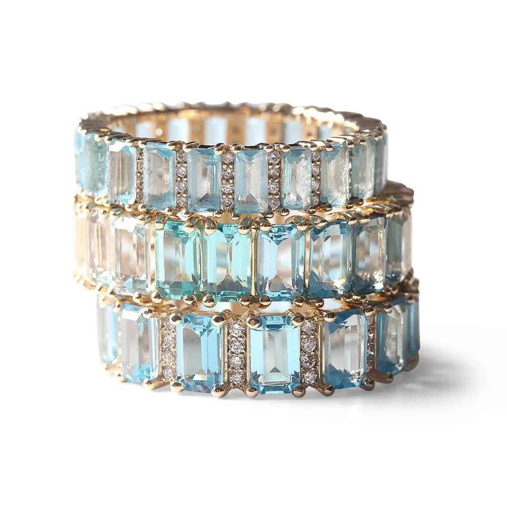 BLUE TOPAZ AND DIAMOND BAGUETTE CUT ETERNITY BAND